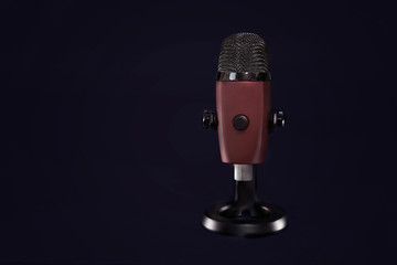 modern microphone on the black background, isolated on black