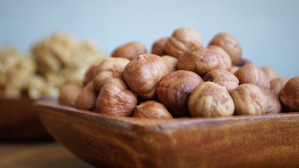 different types of nuts on a wooden dish 