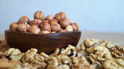 different types of nuts on a wooden dish 