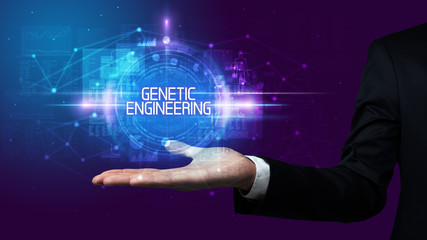 Man hand holding GENETIC ENGINEERING inscription, technology concept