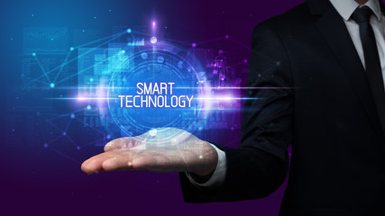 Man hand holding SMART TECHNOLOGY inscription, technology concept