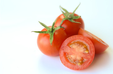 Fresh red tomatoes isolated on white background.