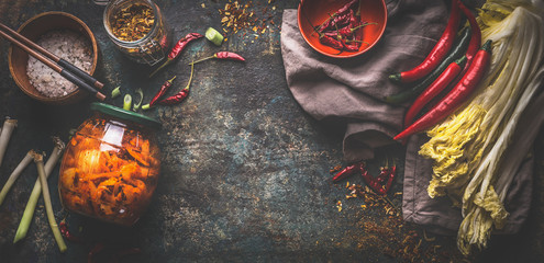 Food background with homemade kimchi in jar, fermented chinese cabbage in hot chili sauce with ingredients. Top view. Banner. Frame