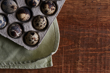 Obraz na płótnie Canvas Quail eggs on wooden table decorated in a rustic style for Easter close-up with empty copy space for text