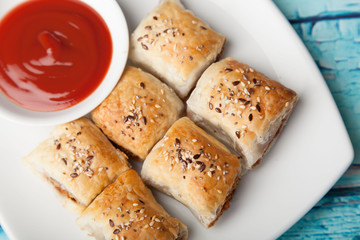 Sausage rolls and tomato sauce 