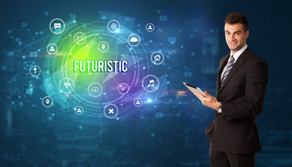 Businessman thinking in front of technology related icons and FUTURISTIC inscription, modern technology concept