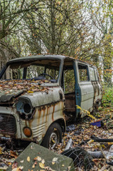 Old rusted abandoned bus in forest