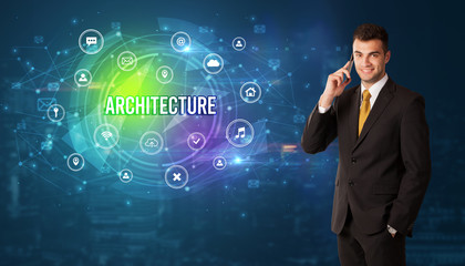 Businessman thinking in front of technology related icons and ARCHITECTURE inscription, modern technology concept
