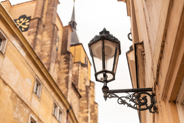 Fototapeta na wymiar The architecture of the old city of Prague. Retro gothic street lamp for street lighting. Photo in the afternoon.