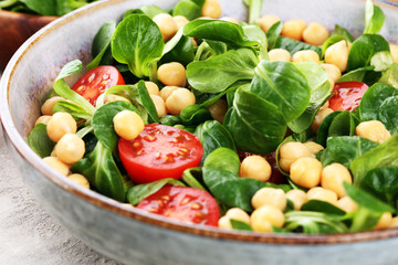 chickpea salad with ingredient and tomatoes and lamb´s lettuce. healthy salad