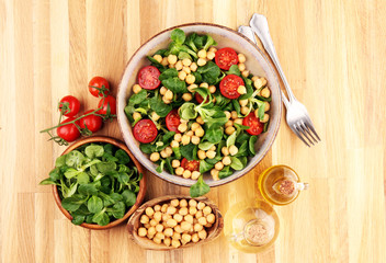 chickpea salad with ingredient and tomatoes and lamb´s lettuce. healthy salad