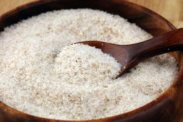 Portion of Psyllium Seeds on rustic dark background. Psyllium seed husks on wood