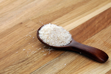 Portion of Psyllium Seeds on rustic dark background. Psyllium seed husks on wood
