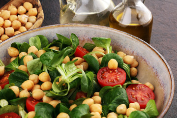 chickpea salad with ingredient and tomatoes and lamb´s lettuce. healthy salad