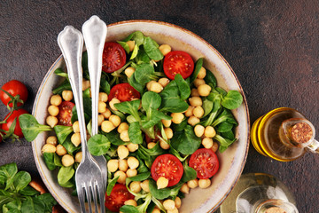 chickpea salad with ingredient and tomatoes and lamb´s lettuce. healthy salad