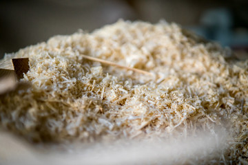 wood saw dust pile at a woodworking workshop.