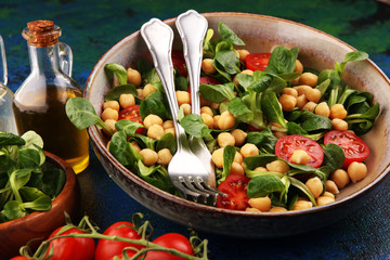 chickpea salad with ingredient and tomatoes and lamb´s lettuce. healthy salad