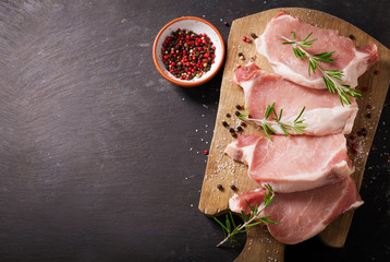 fresh pork chops with rosemary and spices, top view