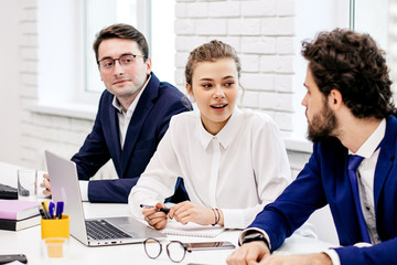 young business leaders gathered in modern office for discussion, diverse people have successful interaction