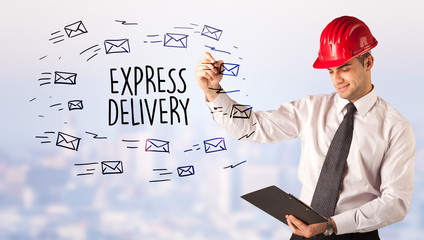 Handsome businessman with helmet drawing EXPRESS DELIVERY inscription, contruction sale concept