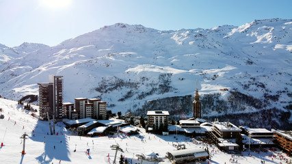 Majestic winter aerial landscape and ski resort with typical alpine wooden houses in French Alps,...