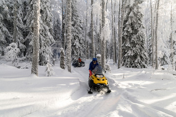 Athletes on a snowmobile.
