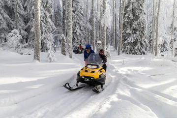 Athletes on a snowmobile.