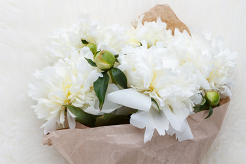 Bouquet of white peonies in eco paper