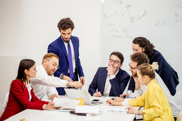 diverse young people in formal wear have conversation, communicate with each other in boardroom, discuss deadline of project and how to reach best results