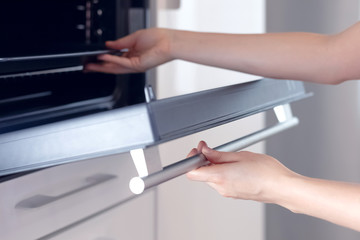 Woman’S Hands Opening Or Closing Oven Door, Closeup And Selective Focus. Young Housewife Cooking, Run Oven.