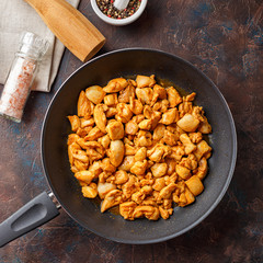 Chicken fillet cut into small pieces for frying in pan