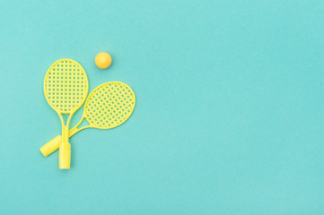 Tennis racket and ball sports on green background.