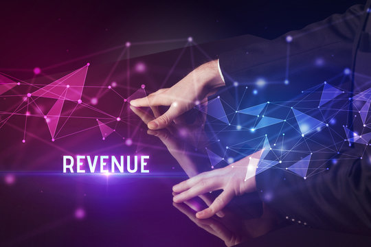 Businessman touching huge screen with REVENUE inscription, modern technology business concept - Powered by Adobe