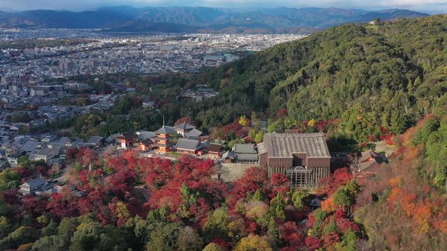 Aerial view of iconic Buddhist temple Kiyomizu-dera in Kyoto City, picturesque autumn scenery with red trees - landscape panorama of Japan from above, Asia