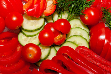 Snack on the festive table. Sliced ​​fresh tomatoes and cucumbers, with a sprig of dill.