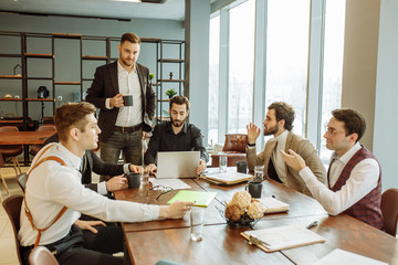 confident successful business crew coworking in office together, men in formal wear gathered to discuss and create business projects