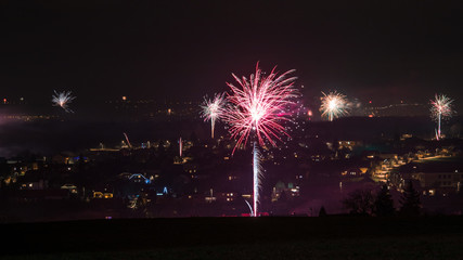 Fireworks light up the sky with above city during New Year celebrations