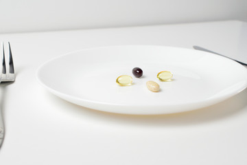 Meal replacement. Multivitamin and mineral supplements. Table set with tablets.