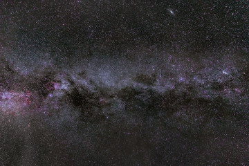 Dramatic Milky Way galaxy arch with purple nebulas in it