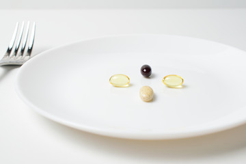 Multivitamin and mineral supplements. Table set with tablets. Meal replacement. First person view.