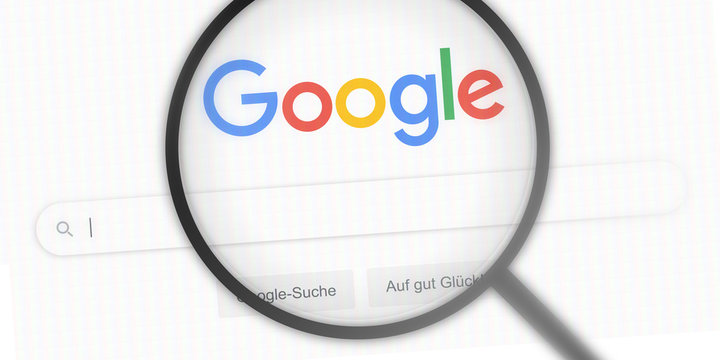 GERMANY - JAN 19, 2020: google.de - website logo / screen under magnifying glass. google search engine / the most used search engine on the world wide web. search bar / editorial banner / close-up.