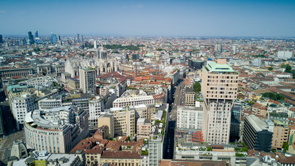 Aerial video shooting with drone on Milan Center, the central business area of the city with new skyscrapers and iconic Cathedral and square of Duomo