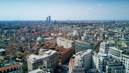 Fototapeta na wymiar Aerial video shooting with drone on Milan Center, the central business area of the city with new skyscrapers and iconic Cathedral and square of Duomo