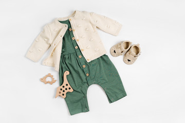 Knitted  jumper  with green romper, wooden toys and baby shoes. Set of baby clothes and accessories...