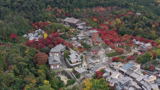 Aerial view of iconic Buddhist temple Kiyomizu-dera in Kyoto City, picturesque autumn scenery with red trees - landscape panorama of Japan from above, Asia