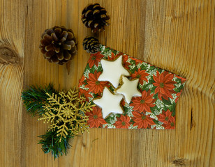 Cinnamon star cookies with pine cones on a napkin