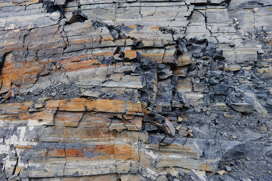Shungite Background, natural mineral stone. Raw shungite mineral, light grey color with a mixture of pink granite. Argentite rock is silver sulfide mineral. Schist is a medium-grade metamorphic rock