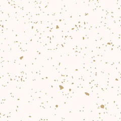 Golden terrazzo flooring texture. Vector seamless pattern with chaotic scattered gold confetti on beige background. Luxury mosaic floor surface. Trendy design for decor, gift paper, textile, prints