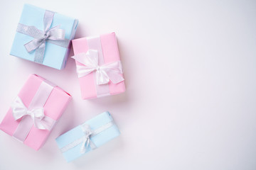 Presents, holiday traditions and shopping. Gift boxes in wrapping paper and tied with satin ribbon on white background, copy space