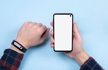 Smartphone in men's hands. A Cup of coffee, a smart watch on your hand.